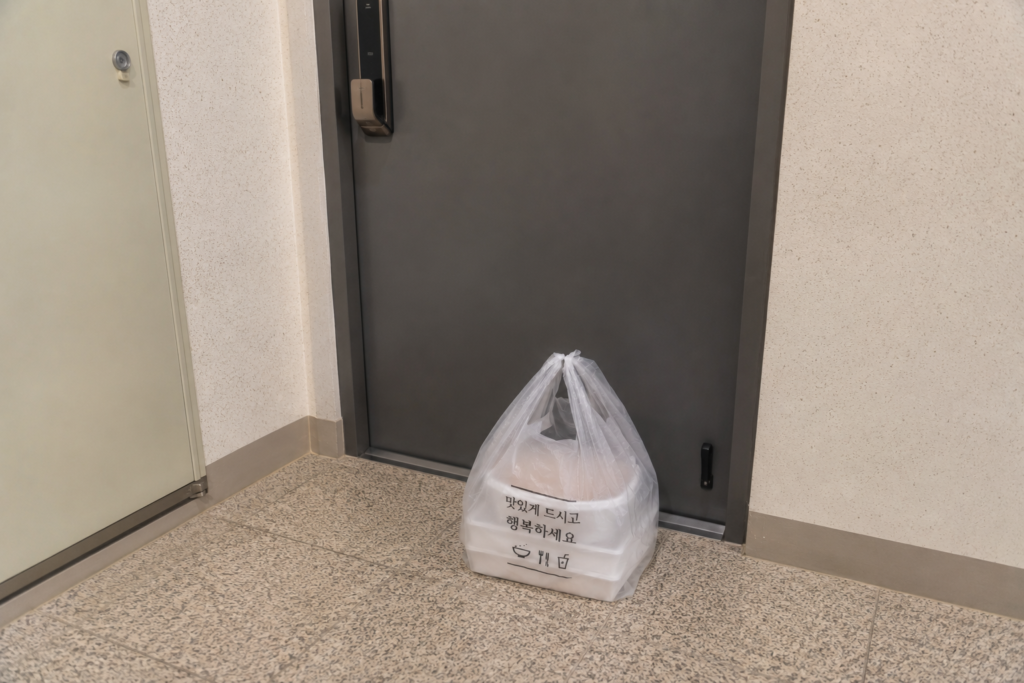 Why Do Koreans Order Food Delivery for Everything? Korean food delivery left neatly outside an apartment door.
